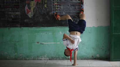 Chinese child doing a cartwheel