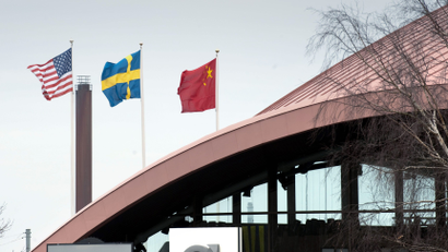 The flags of the United States, (L-R), Sweden and China fly outside the Volvo Hall at the Volvo plant and headquarters in Torslanda, Gothenburg, Sweden, March 28, 2010. Chairman of Zhejiang Geely Holding Group Li Shufu reached a deal in March 2010 to buy Volvo Cars for $1.8 billion -- less than a third of what Ford had paid a decade ago -- plus an additional $900 million in investment. The agreement is the latest example of China's growing clout on the international stage.