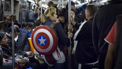 A woman in costume rides the subway at the conclusion of the first day of New York Comic Con in Manhattan