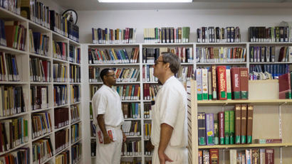 prisoners among books in a library