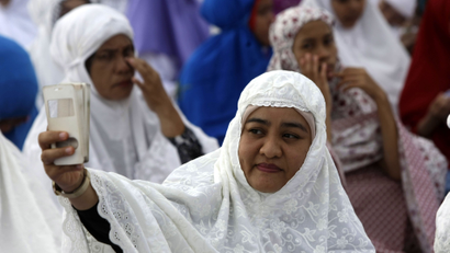 A picture made available 26 September 2016 shows a Muslim woman taking a selfie during a mass prayer session, in Banda Aceh, Indonesia, 12 September 2016. South-east Asian nations are cashing in on increasing earnings in the tourism sector from Islamic travelers, and 'Halal Tourism' is reported to be among the fastest growing travel groups. Among other things on offer to Muslim travelers is halal food permitted by Islam, available in specially dedicated restaurants and shops, with no alcohol, and accommodation enabling suitable places for prayer, male and female segregation such as women-only swimming pools and private beaches, conservative uniforms for hotel serving staff, and copies of the Koran in rooms. United Nations World Tourism Day celebrations will be observed on 27 September 2016.
