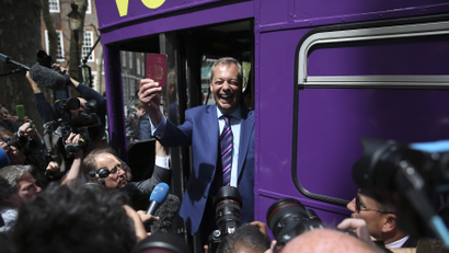 Leader of the United Kingdom Independence Party Nigel Farage holds his passport as he launches his party's EU referendum tour bus in London