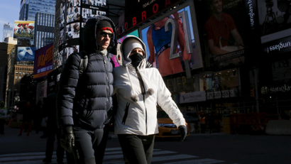 People are seen bundled up from the cold in Times Square, NewYork February 12, 2016.