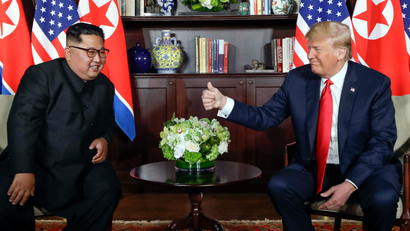 U.S. President Donald Trump gives North Korean leader Kim Jong Un a thumbs up during their meeting at a resort on Sentosa Island in Singapore on Tuesday, June 12, 2018.