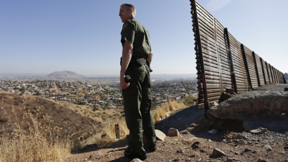 In this June 13, 2013 file photo, US Border Patrol agent Jerry Conlin looks out over Tijuana, Mexico, behind, along the old border wall along the US - Mexico border, where it ends at the base of a hill in San Diego. After dropping during the recession, the number of immigrants crossing the border illegally into the U.S. appears to be on the rise again, according to a report released Monday, Sept. 23, 2013 by Pew Research Center's Hispanic Trends Project.
