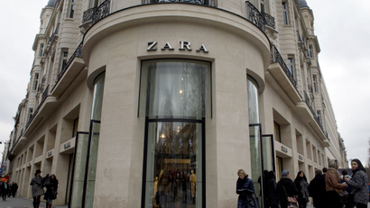 People go shopping at a Zara store on the Champs-Elysees avenue in Paris, on February 15, 2015.