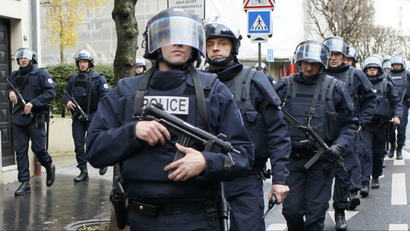 French intervention police take up position near the scene of a hostage taking at a kosher supermarket in eastern Paris January 9, 2015.