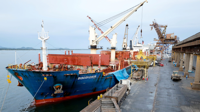 An ocean freighter unloads soybeans at a dock.