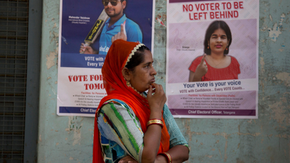 An Indian women stand outside a polling booth to cast her vote in Hyderabad, India,