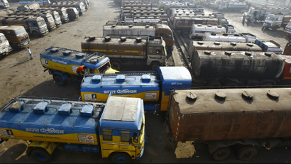 Oil tankers are seen parked at a yard outside a fuel depot on the outskirts of Kolkata.