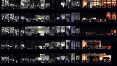 Workers are seen in an office tower