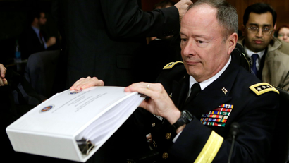U.S. National Security Agency (NSA) Director General Keith Alexander pulls out a binder before testifying at the Senate Judiciary Committee in Washington December 11, 2013.