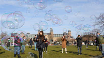People make soap bubbles during a protest against restrictions put in place to curb the spread of the coronavirus disease (COVID-19), in Amsterdam, Netherlands