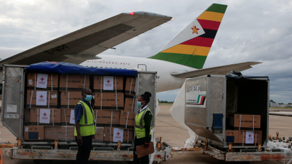 Workers offload Zimbabwe's first batch of COVID-19 vaccines from China on Feb. 15.