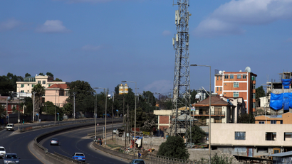 Motorists drive past an Ethio-Telecom network tower in Addis Ababa, Ethiopia.