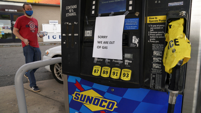 A sign at a gas station pump reads, "Sorry, we are out of gas."