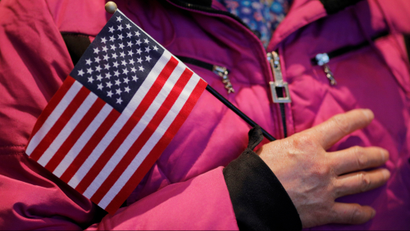 Seventy-three year-old Dianrong Wang of China holds a U.S. flag as the National Anthem is sung during a citizenship ceremony at the John F. Kennedy Presidential Library in Boston, Massachusetts, U.S. February 8, 2017.