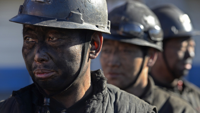 Miners wait in lines to shower during a break near a coal mine in Heshun county, Shanxi province