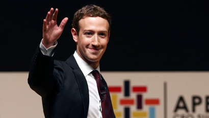 Facebook founder Mark Zuckerberg waves to the audience during a meeting of the APEC (Asia-Pacific Economic Cooperation) Ceo Summit in Lima, Peru, November 19, 2016.