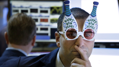 A trader wearing "Happy New Year" glasses at the NYSE