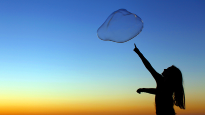 A girl plays with a giant bubble as the sun sets at Moonlight Beach in Encinitas, California June 30, 2011. Picture taken June 30.