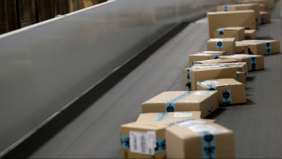 Picture showing Amazon packages on a conveyor belt.