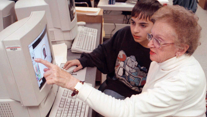 Clare Meadows, right, asks Dominic Penn, 13, a question as he helps her during a senior citizen class on computers at the Chestnut Ridge Middle School, in Washington Township, N.J., on Wednesday, Nov. 5, 1997. The five-week course was the first sponsored by the school district specifically for senior citizens. (AP Photo/Allen Oliver)