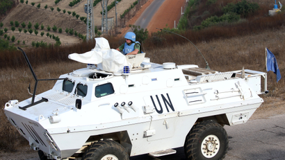 A UN peacekeeper (UNIFIL) patrols the border with Israel in the village of Khiam