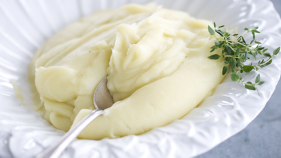 white bowl with mashed potatoes and thyme