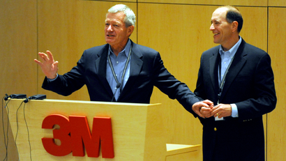 In this photo taken July 8, 2013, Senate Finance Committee Chairman Sen. Max Baucus, D-Mont., left, and the House Ways and Means Committee Chairman, Rep. Dave Camp, R-Mich., talk about tax reform to 3M employees at the 3M Innovation Center in Maplewood, Minn. Two of the most powerful members of Congress, Baucus, a Democrat, and Camp, a Republican, are touring the country to rally support for their effort to overhaul the nation’s tax laws. They've developed a close friendship as they work to attract other lawmakers to their cause while helping Democrats and Republicans get to know each other a bit better. Their secret weapon: burgers and beer.