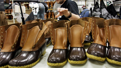 FILE - In this Dec. 14, 2011, file photo, Eric Rego stitches boots in the facility where LL Bean boots are assembled in Brunswick, Maine. L.L. Bean will freeze its pensions and offer an early retirement program in 2018 as it seeks to control growing expenses. Steve Smith, the Maine-based retailer's CEO, is making the announcement in a memo and in meetings with workers on Thursday, Feb. 9, 2017. (AP Photo/Pat Wellenbach, File)