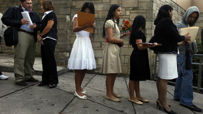 Hondurans wait in line to apply for visas to the US.