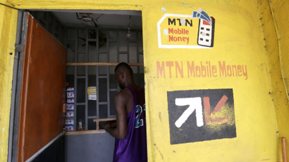 A man withdraws money at an MTN Money cashier booth, in Abidjan, Ivory Coast, 10 May 2017. This mobile phone-based payment system allows customers to use their phones to pay their bills or to transfer funds to any other phone subscriber.