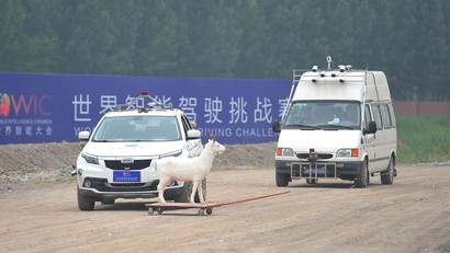 A self-driving vehicle (L) takes part in an autonomous driving contest held as a part of the World Intelligent Congress, in Dongli district of Tianjin, China May 15, 2018. Picture taken May 15, 2018.