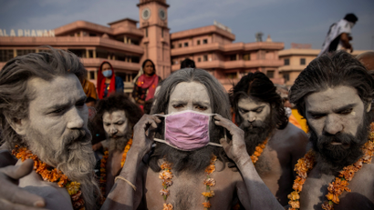 A Naga Sadhu, or Hindu holy man wears a mask before the procession for taking a dip in the Ganges river during Shahi Snan at "Kumbh Mela", or the Pitcher Festival, amidst the spread of the coronavirus disease (COVID-19), in Haridwar