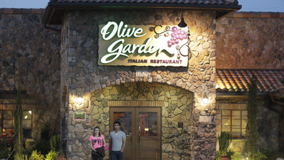 Two customers in front of Olive Garden restaurant.