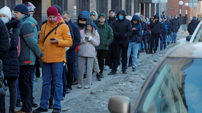 Russians queue up to withdraw cash from an ATM in St Petersburg.