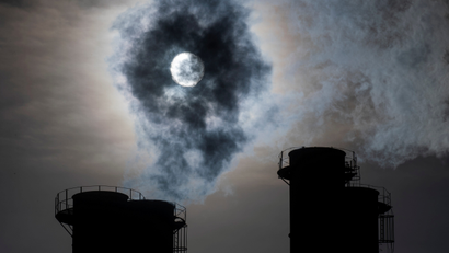 Sun shines through steam rising from chimneys of a power plant in Moscow.