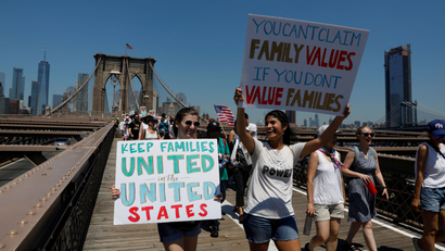 Demonstrators march on Brooklyn Bridge during "Keep Families Together" march to protest Trump administration's immigration policy in New York