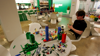 An employee plays with lego at the New York City offices of Google , March 10, 2008.