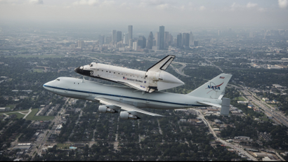 Handout of the space shuttle Endeavour, atop NASA's Shuttle Carrier Aircraft at it flies over Houston