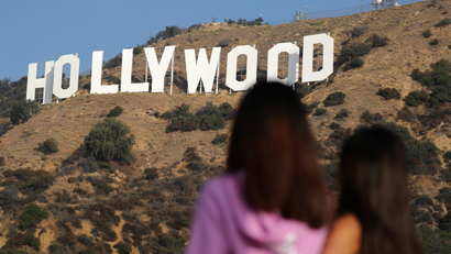 Women look at the Hollywood sign in Hollywood
