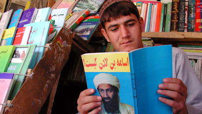 An Afghan book-seller reads a book on Saudi-born dissident, Osama bin Laden in the capital on September 17, 2001. The United States have named bin Laden as the prime suspect in the co-ordinated attacks against America last week and has threatened to launch an assault on Afghanistan to punish him. Afghans are nervous and worried about the attack as bin Laden denies links with the deadly incidents.