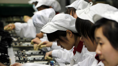 Staffs works on the production line at the Foxconn complex in the southern Chinese city of Shenzhen, Southern city in China, Wednesday, May 26, 2010. The head of the giant electronics company whose main facility in China has been battered by a string of worker suicides opened the plant's gates to scores of reporters Wednesday, hours after saying that intense media attention could make the situation worse. ()