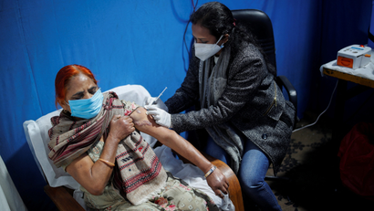 Woman receives a booster dose of a COVID-19 vaccine Covaxin in New Delhi