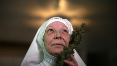 California "weed nun" Christine Meeusen, who goes by the name Sister Kate, poses for a portrait with hemp.