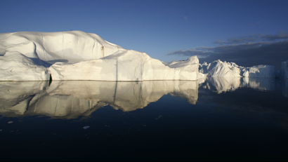 Icebergs are reflected in the calm waters at the mouth of the Jakobshavn ice fjord near Ilulissat in Greenland in this photo taken May 15, 2007.