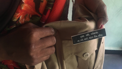 Police constable Meena Ghodke pins her name tag on her on uniform at her home in Beed, India, June 17, 2019. THOMSON REUTERS FOUNDATION/Roli Srivastava