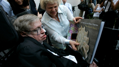 Stephen Hawking looking at a book
