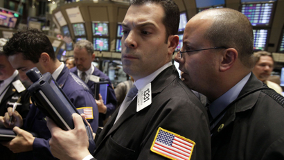One trader whispering to another on the floor of the New York Stock Exchange.